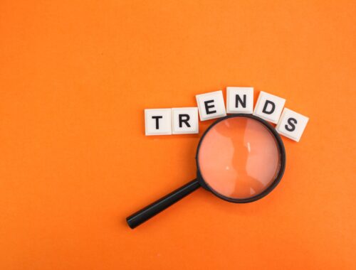 magnifying glass and letters of the alphabet with the word trends.