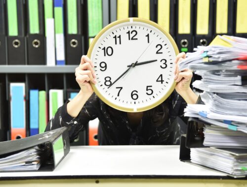office worker holding a clock, working overtime and lot of work, time management concept. Office worker holding a clock, Working overtime and lot of work, Time management concept.