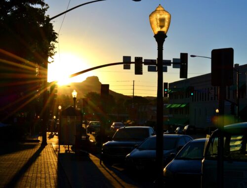 Sunset shining through the streets of Prescott AZ illuminating a Street lamp.